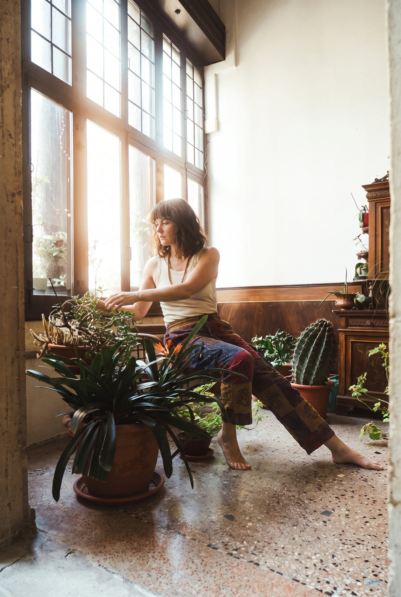 Ana wearing the Emberglow Patchwork Pants, plant room