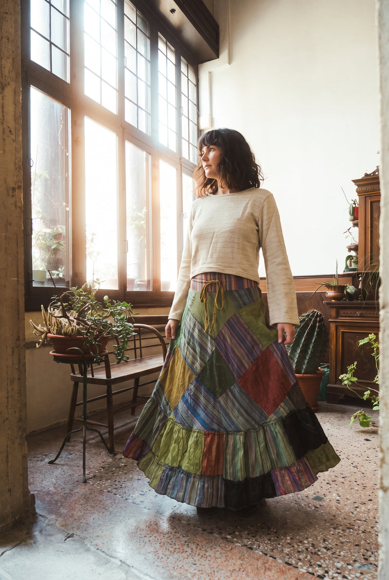 The Fern Hollow Patch Skirt swaying, diagonal patch panels and deep ruffled hem.