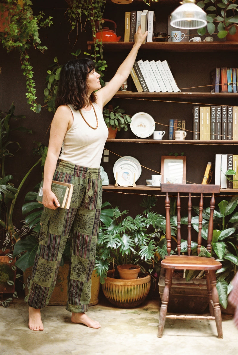 Ana wearing the Mossline Patchwork Pants, plant room
