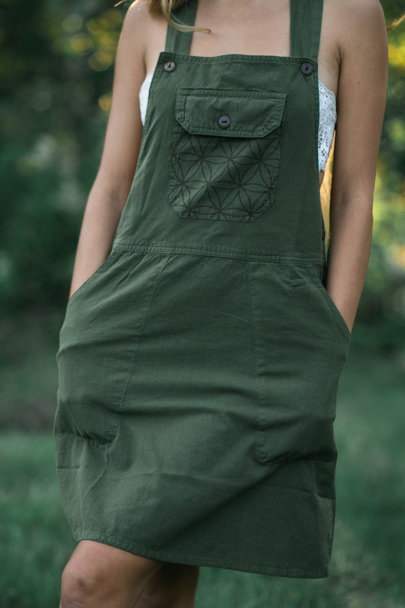 Sage green Rainforest Dress with straps, chest pocket embellished with geometric embroidery, knee-length silhouette.