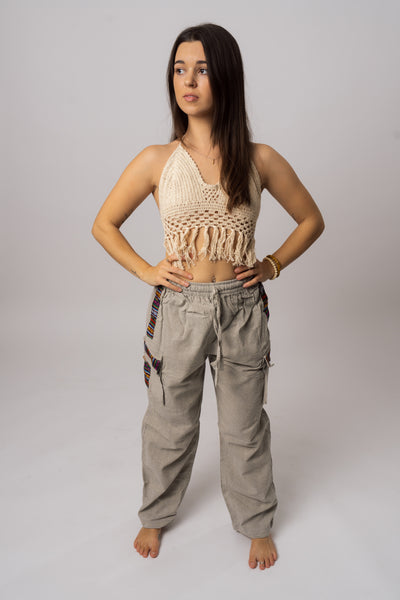 Grey Hippie Pants in linen with colorful striped side pockets and elastic waist, shown on a model.