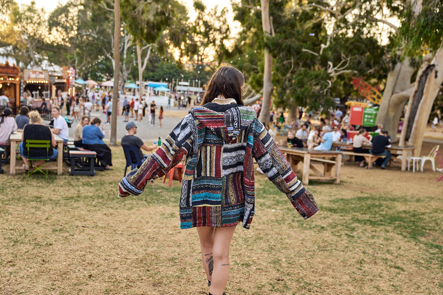 Customer wearing a Hippie Hut patchwork jacket at Adelaide Fringe