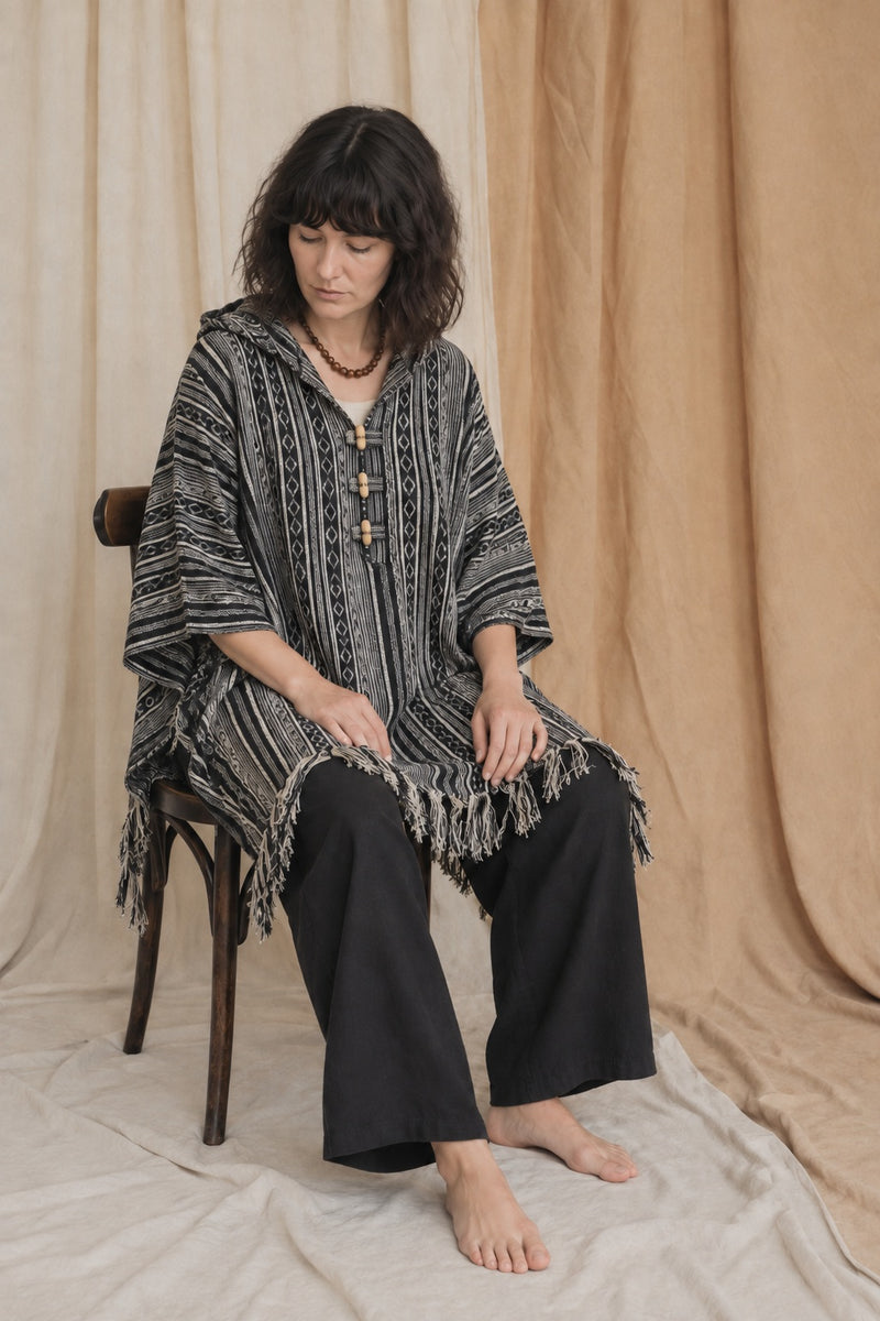Ana seated in the Handmade Black Nepalese Poncho, studio