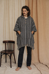 Reed wearing the Handmade Black Nepalese Poncho, front view, studio