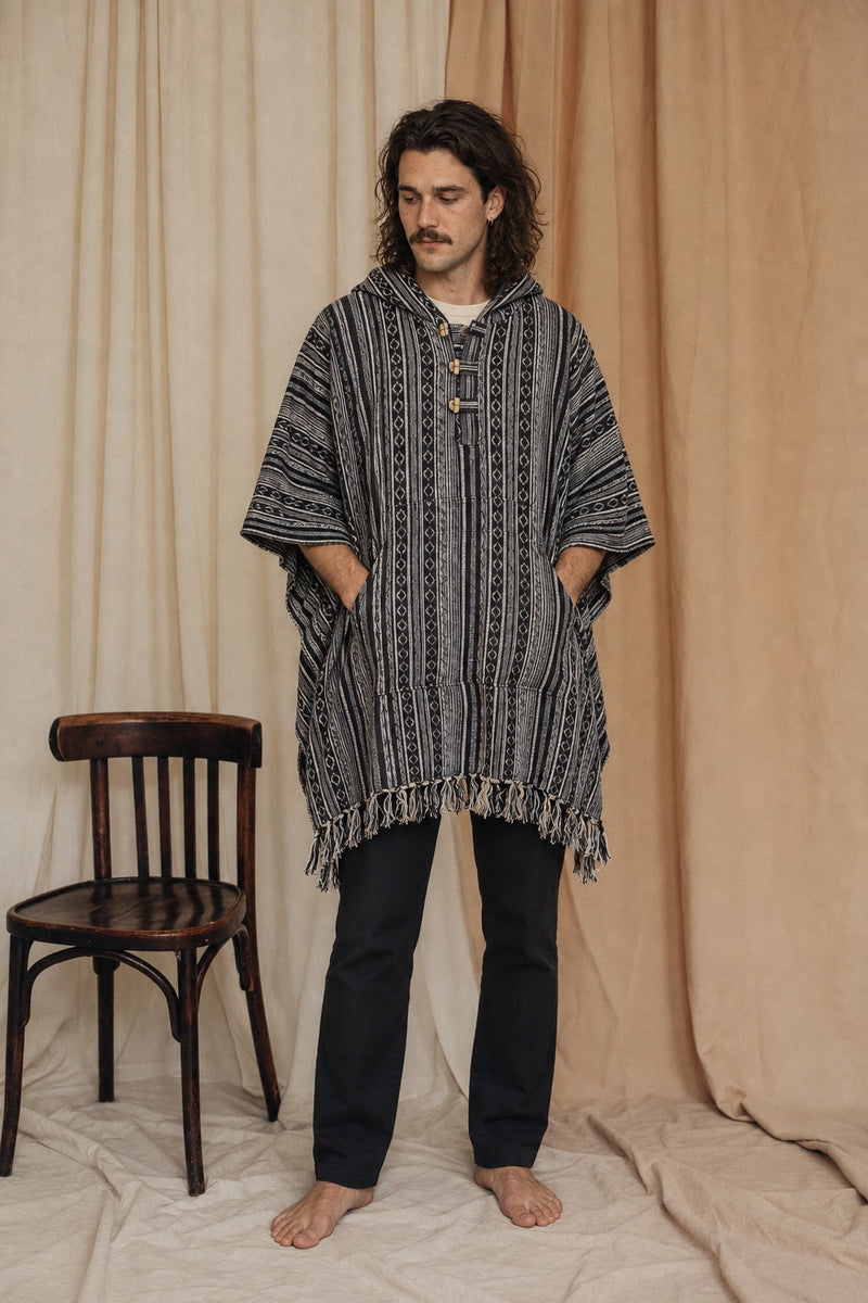 Reed wearing the Handmade Black Nepalese Poncho, front view, studio