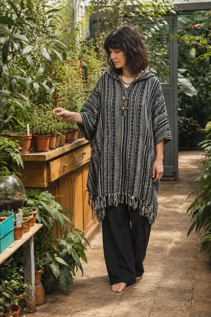 Ana wearing the Handmade Black Nepalese Poncho, greenhouse