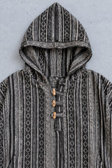Close-up of the Handmade Black Nepalese Poncho hood, toggles and woven stripe