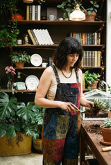 Ana wearing the Emberfield Overalls, plant room