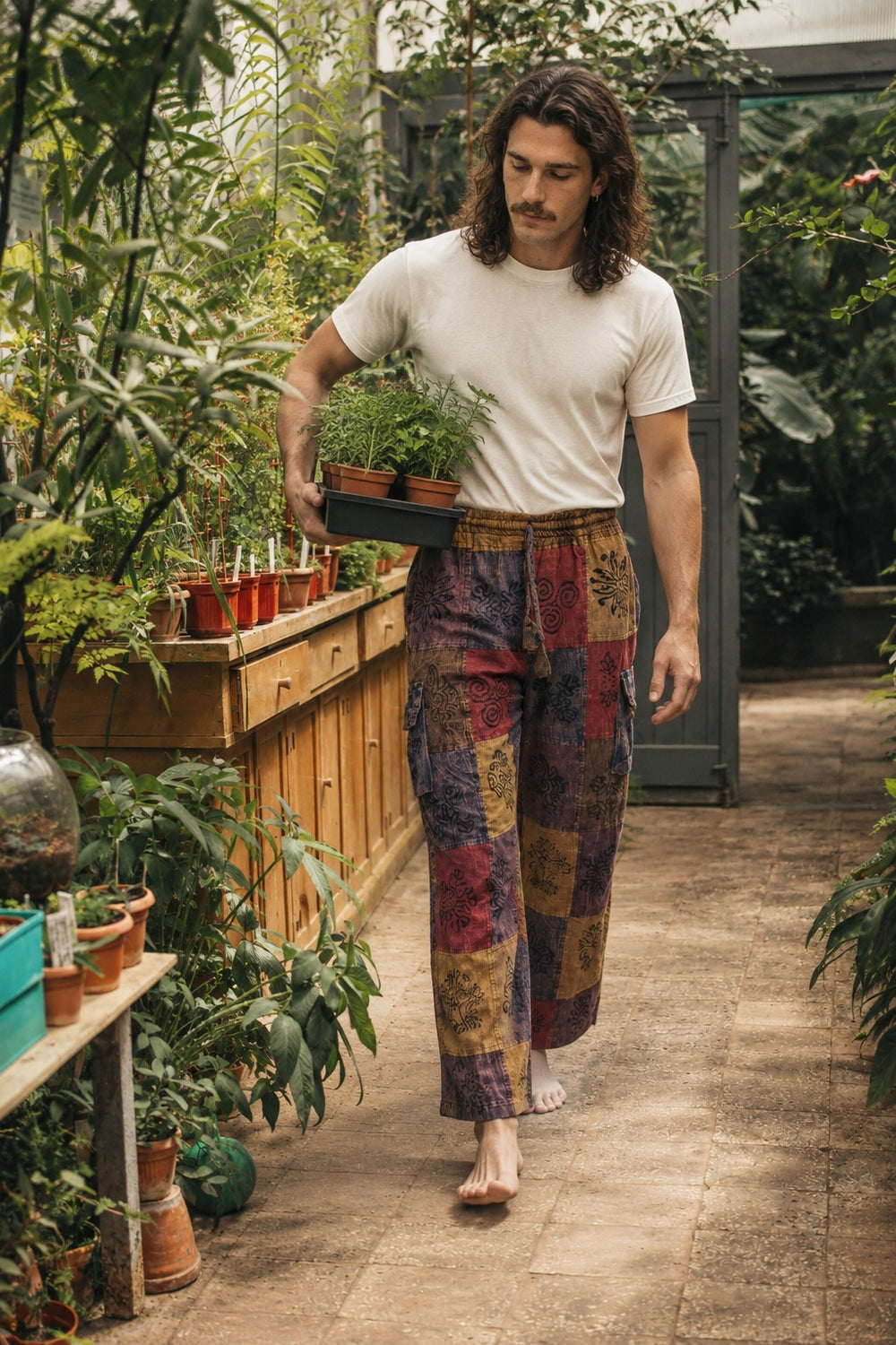 Reed wearing the Emberglow Patchwork Pants, lifestyle