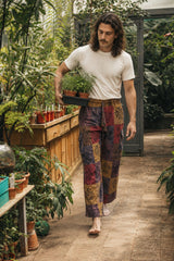 Reed wearing the Emberglow Patchwork Pants, lifestyle