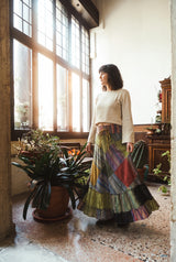 Model wearing the Fern Hollow Patch Skirt: tiered stonewashed patchwork maxi in motion.