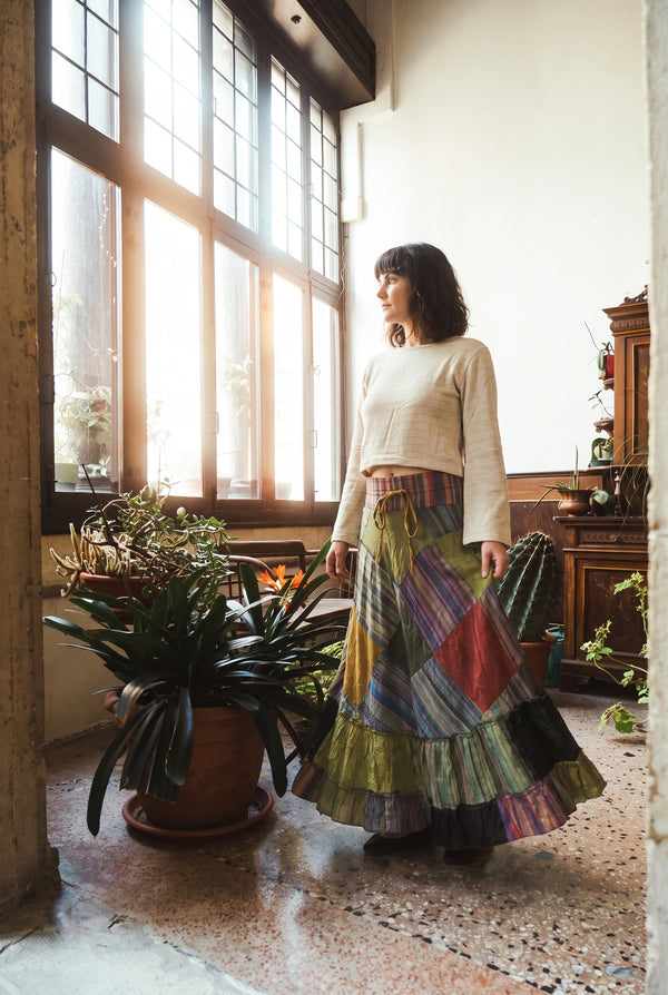 Model wearing the Fern Hollow Patch Skirt: tiered stonewashed patchwork maxi in motion.