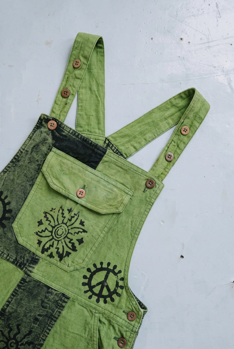 Close-up detail of the Fernbrook Overalls in Forest, block print and stitching