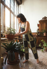 Ana wearing the Mosslight Overalls, plant room