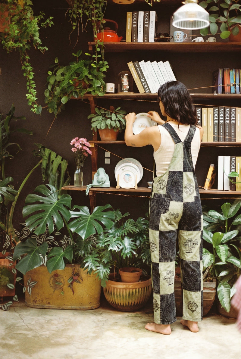 Ana wearing the Mosslight Overalls, plant room