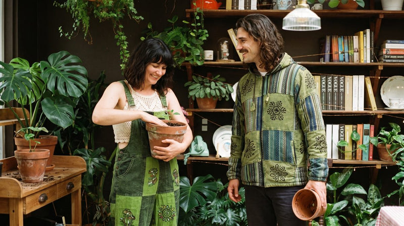 Sungrove Overalls front-on, lime and forest-green patchwork with block-printed mushrooms and sunbursts.