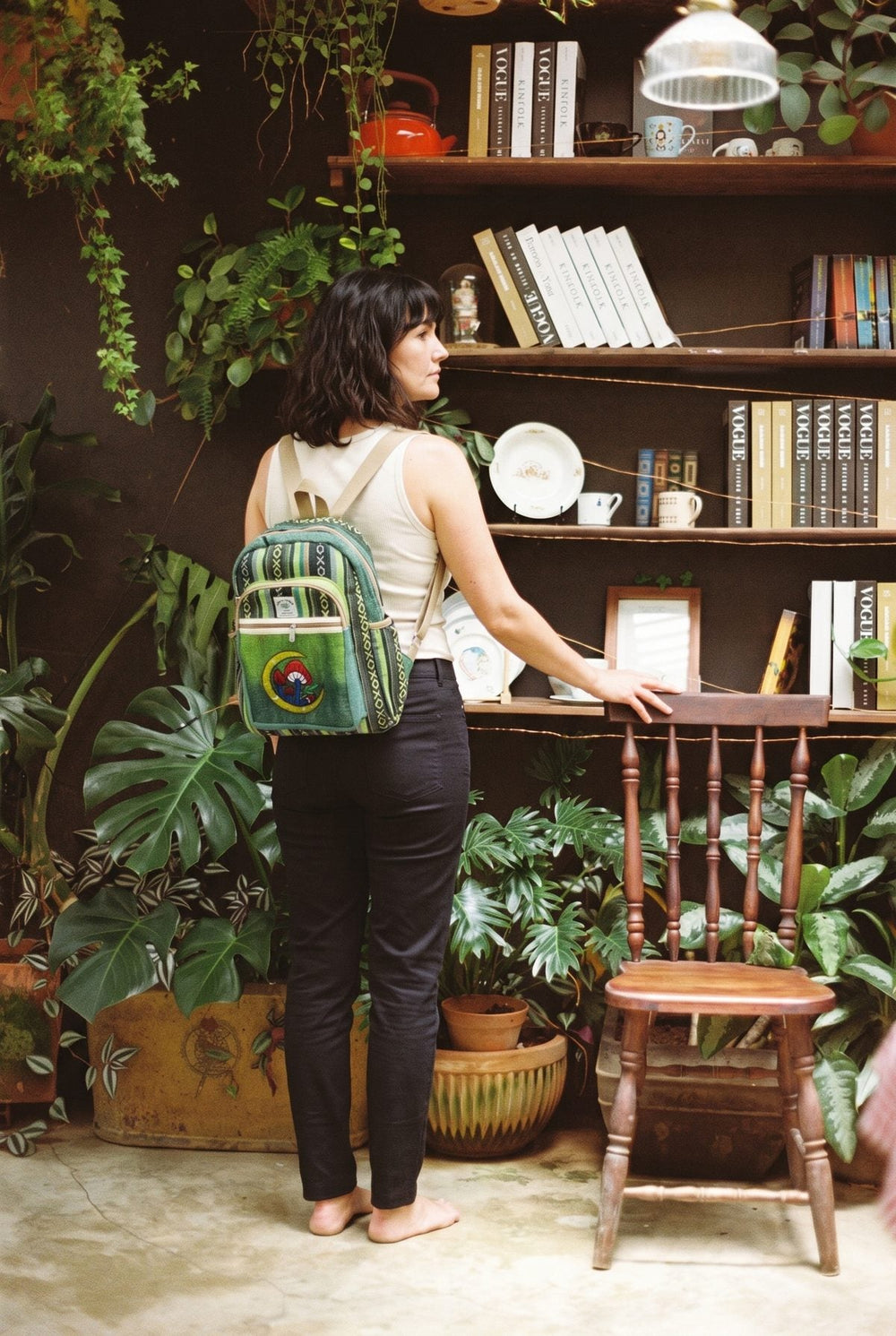 Moonshroom Gheri Backpack worn over a cream tank, green hemp gheri with mushroom and moon applique.