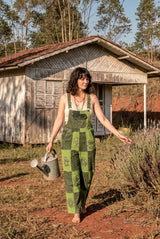 Sungrove Overalls front-on, lime and forest-green checkerboard patchwork with printed mushrooms and sunbursts.