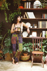 Duskwood Overalls square to camera, purple, olive and rust patchwork with flower and mandala thigh panels.