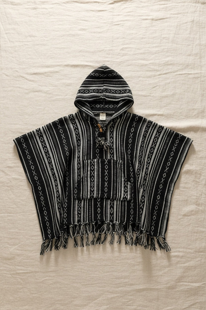 Kids Black Poncho flat lay on linen