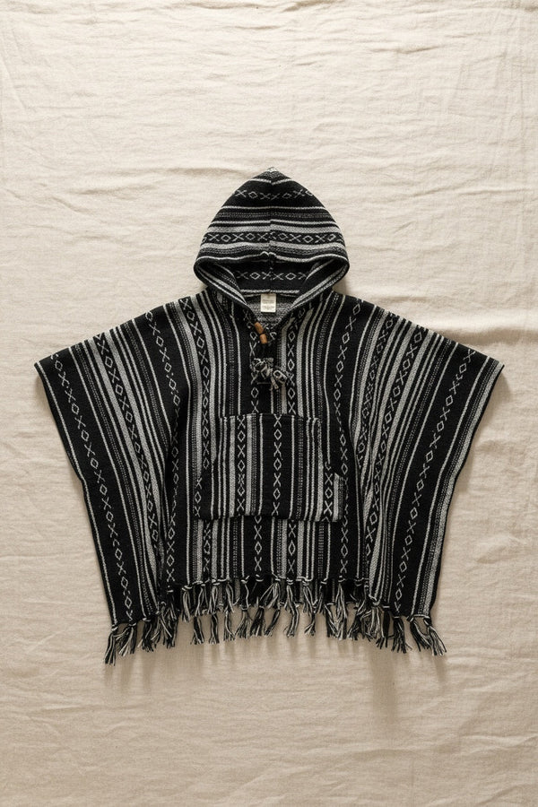 Kids Black Poncho flat lay on linen