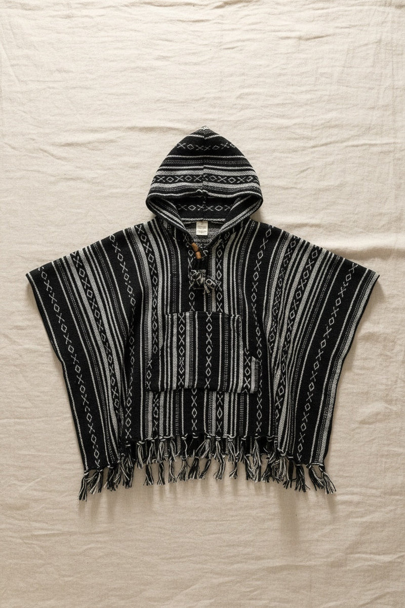 Kids Black Poncho flat lay on linen