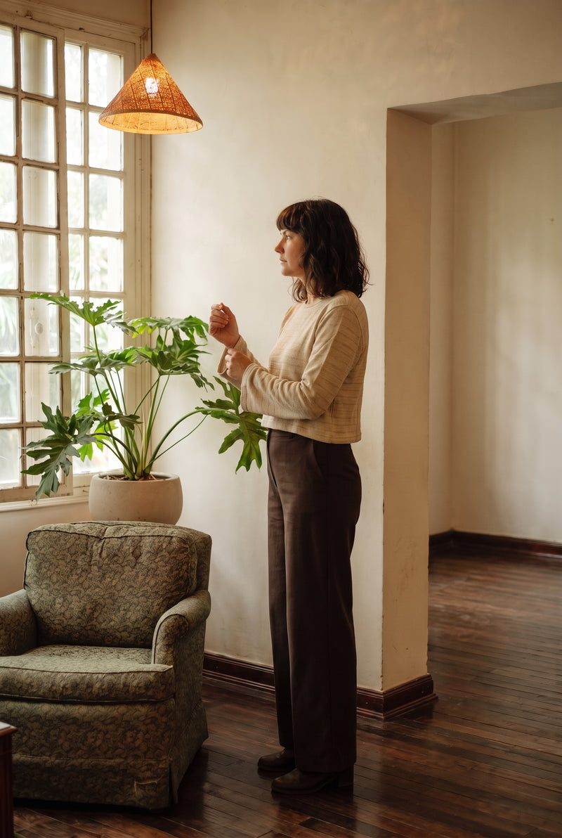 The Lichen Knit Top in Oat by the window.