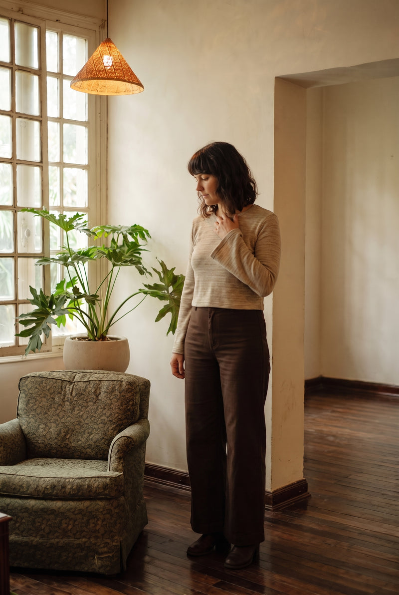 The Lichen Knit Top in Oat styled with wide-leg trousers.