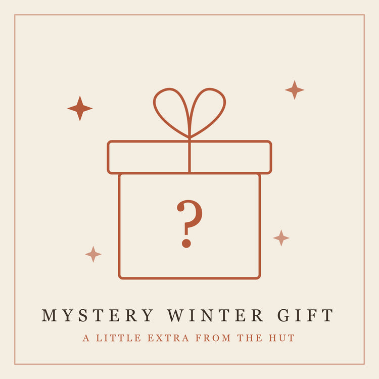 Rust-colored outlined gift box with heart-shaped bow and question mark, surrounded by decorative stars on cream background.