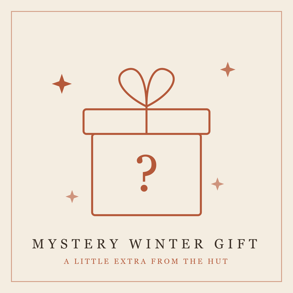 Rust-colored outlined gift box with heart-shaped bow and question mark, surrounded by decorative stars on cream background.