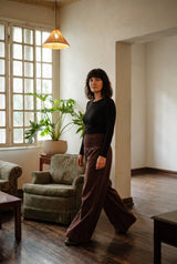 The Peatfield Wide-Leg Pants in Cocoa mid-step, floor-length drape.