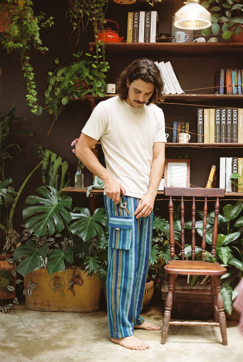 Close view of the deep flapped cargo pocket on the Riverstone Gheri Cargo Pants in blue woven stripe