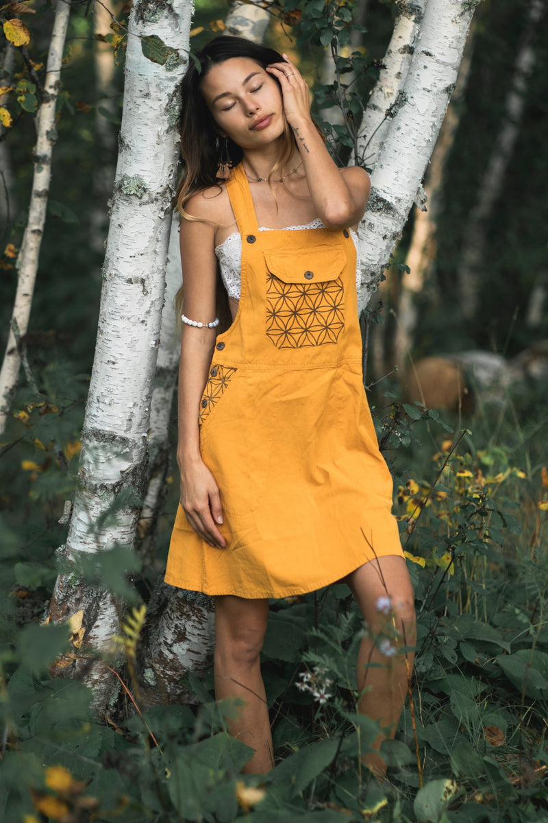 Mustard yellow Sunflower Dress featuring geometric triangular patterns and white lace neckline trim.