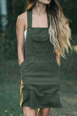 Rainforest Dress in olive green with square neckline, straps, front pocket with geometric embroidery, and button.