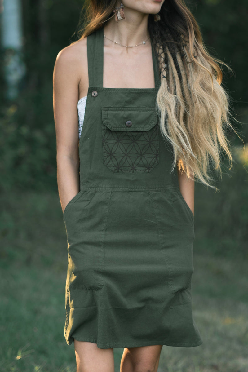 Rainforest Dress in olive green with square neckline, straps, front pocket with geometric embroidery, and button.