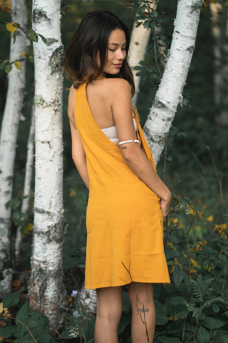 Sunflower Dress in bright yellow, sleeveless with an asymmetrical draped neckline.